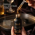 Blunt Gold CBD:THC 1:7 8000mg oil bottle with dropper being used, set against a dark background.